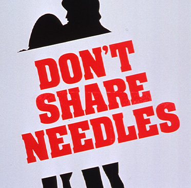 Black silhouette of a man and woman with “Don’t share needles” in red through the middle of the silhouette.  