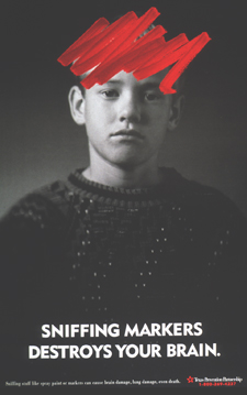 Red magic marker is scribbled on the forehead of a boy. Below the boy is the title Sniffing Markers Destroys Your Brain.
