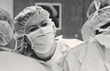 A woman and two other people in surgical garments