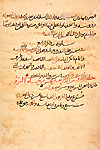 Folio 231b of Abū Bakr Muḥammad ibn Zakarīyā’ al-Rāzī's Kitāb al-Ḥāwī fī al-ṭibb (The Comprehensive Book on Medicine) featuring the final page with the colophon in which the unnamed scribe gives the date he completed the copy as Friday, the 19th of Dhu al-Qa‘dah in the year 487 [= 30 November 1094]. The almost matte-finish, fairly opaque, brown paper has unevenly dispersed fibers with scattered large inclusions and occasional thin patches. The text is written in a medium-large to very-large rather cursive naskh script with minimal diacritical dots using brown ink fading to a lighter shade, with headings in red and text-stops indicated by a red circle enclosing a dot.