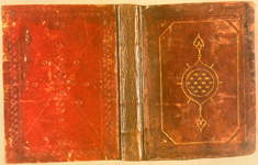 The front and back covers of of Shams al-Dīn al-Dimashqī's Kitāb al-Jalil fi ‘ilm al-firāsah  (An Important Book on the Science of Physiognomy). The front or upper cover is a 15th-century Egyptian/Syrian binding of brown leather over pasteboards. The frame is formed of blind-tooled fillets either side of a running pattern made of impressions of a rectangular stamp with a vegetal design. The inner panel is defined by fillets, one of which is painted gold; the decorative devices in the corners are also painted gold. At the center of the inner panel is a circular medallion filled with interlocking strapwork, highlighted with gold paint. The circular medallion has a gold-painted outline with points in ogival form passing through a bar-shaped vestigal ring to end in finials, all outlined in gold. The back cover is of red leather over pasteboards. At the center is a symmetrical vegetal design, blind stamped, surrounded by smaller S-shaped stamps and flower-heads aligned along blind-tooled lines markings the horizontal, the vertical, and the diagonals. There is a wide frame formed of three blind-tooled fillets either side of a row of S-stamps, with small flower-heads at the corners.