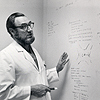 Dr. C. Everett Koop stands at a whiteboard, on which he has laid out the details of the surgery for separating the Rodriguez twins.