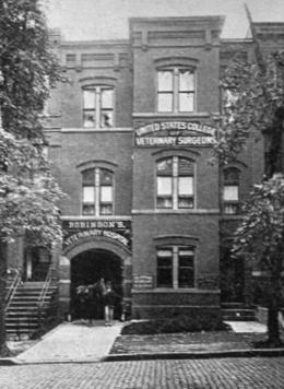 A black and white front view of the U.S. College of Veterinary Surgeons - a multi-story brick building at the foot of Capitol Hill.