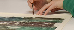 A conservator works on a painting.