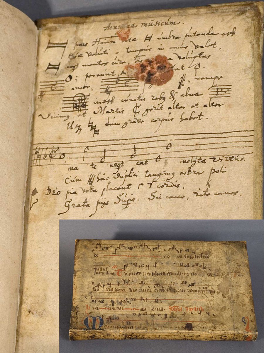 An open book with handwritten text and music, an inset shows the velum cover also with handwritten music notation.