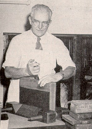A halftone image of an older white man in an apron working on the spine of a book.