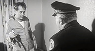 A policeman confronts a man with a knife.