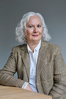 Photograph of a white woman with white hair.