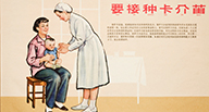 A nurse looks at an infant in a woman's lap.