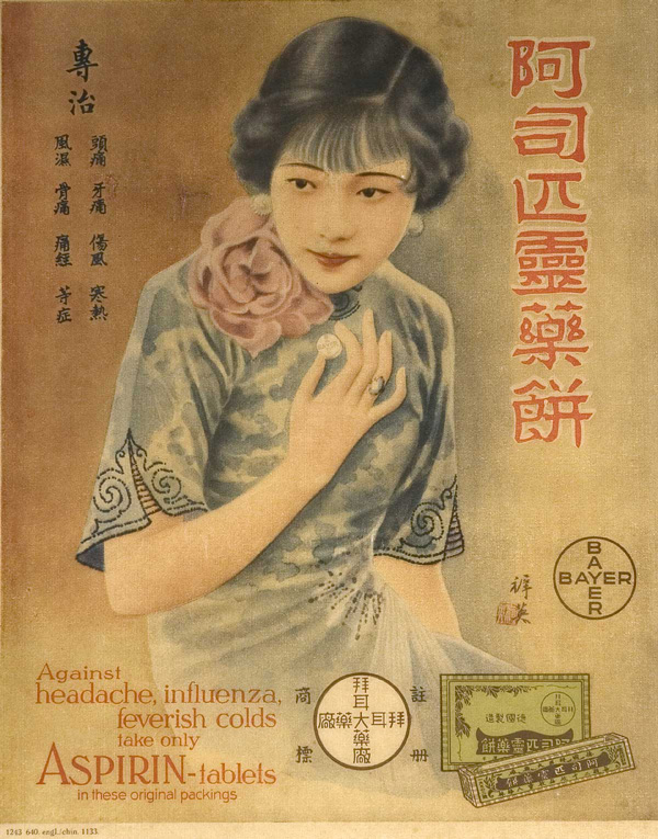 Advertisement featuring an image of a woman in a blue dress holding an aspirin tablet in her hand, below her is a box of tablets and the Bayer logo