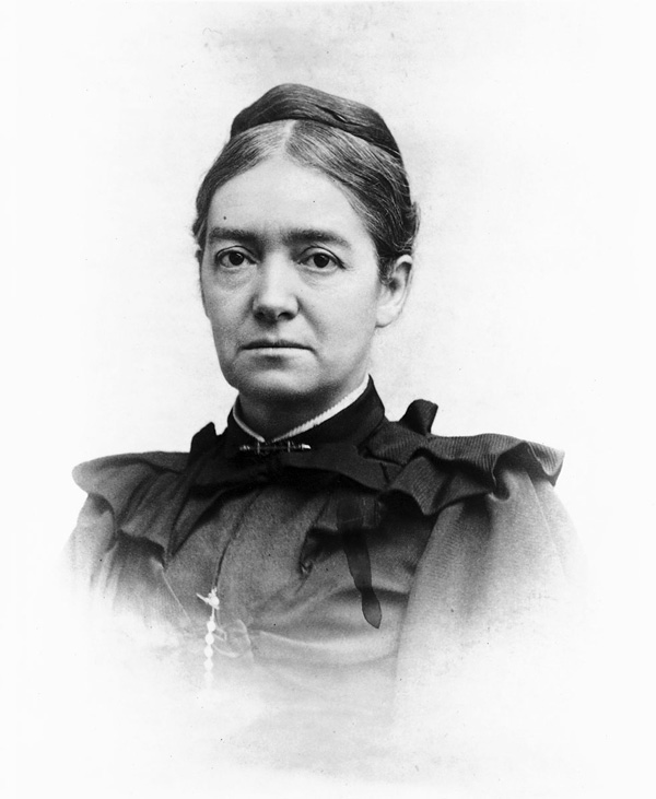 A formal black and white photographic portrait of a white woman