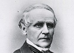 Formal photograph of an older white man in a suit.