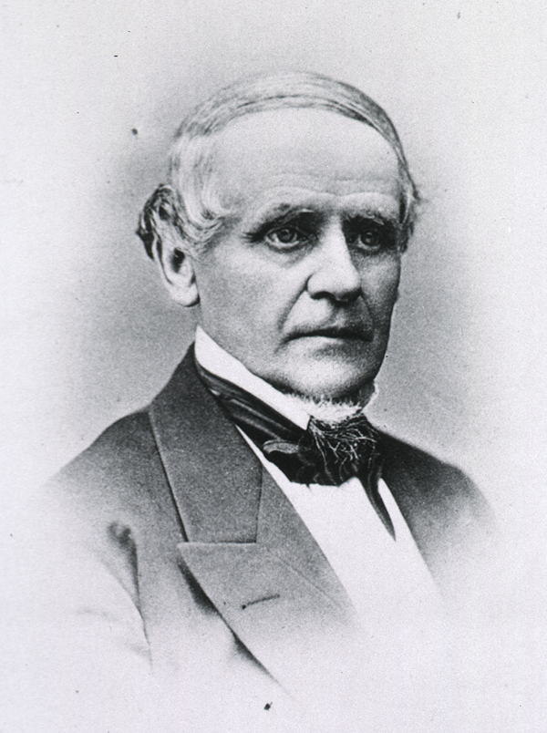 Formal photograph of an older white man in a suit.