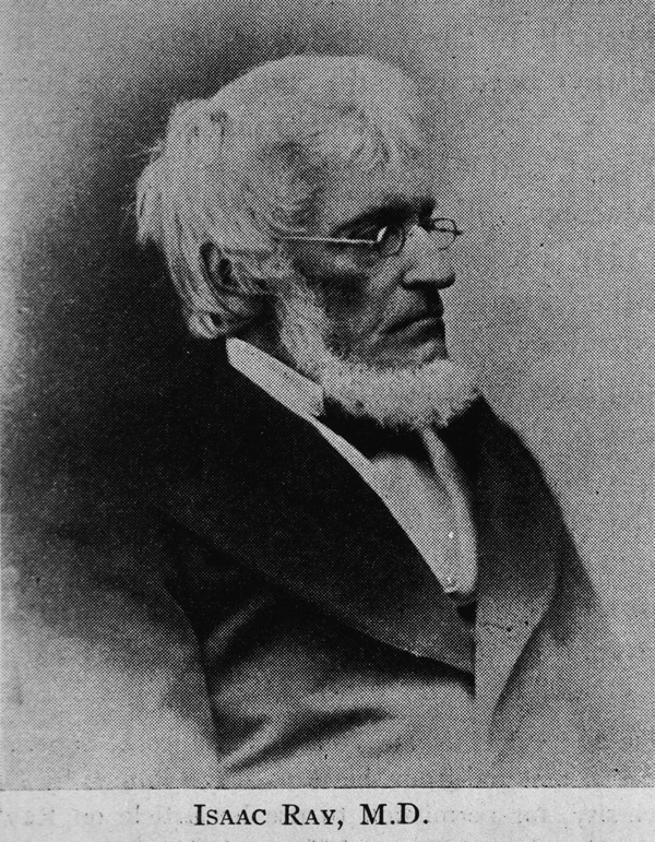 Formal photographic portrait an older, bearded, white man, seated, wearing glasses.