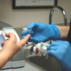 An photo of a nurse taking a patient's blood for the A1C test