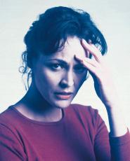 Photograph of a woman with a headache