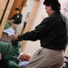 Photograph of a senior man in physical therapy