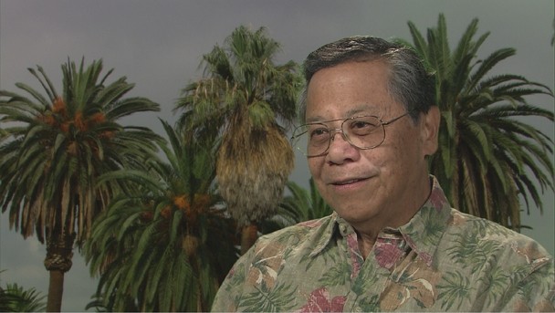 Color image of Benjamin Young, M.D. wearing glasses and a patterned, button-up shirt.