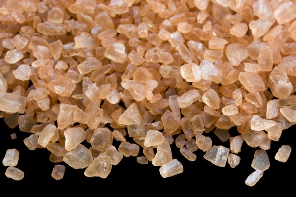 Color image of several rocks of sea salt with an orange-brown hue.