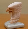 Three-dimensional eagle head carved from soapstone.
