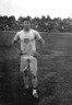 Black and white photograph of Jim Thorpe standing with his hands on his hips.