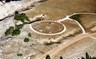 Color image of a large circular design embedded in the ground as seen from the air.