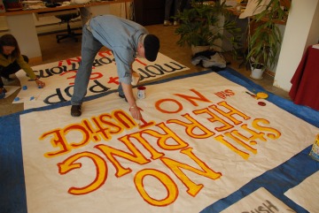 Man Paints a Supreme Court Exxon Valdex Court Ruling Protest Banner