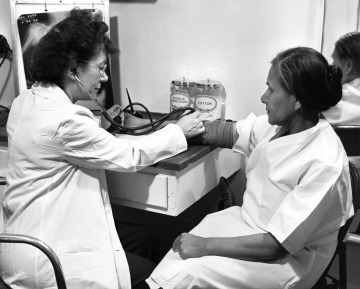 A nurse checks a woman's blood pressure onboard the vessel Hygiene.