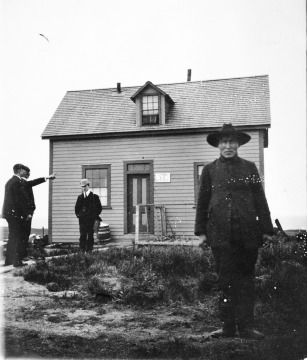 Four men outside U.S. Land Office.