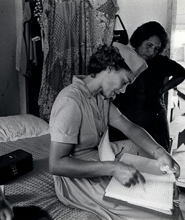 Health Aide Dorthy Press visits a migrant family in migrant workers’ camp outside Nassawadox, Virginia, photograph by Janet Ochs for Public Health Service World, 1966