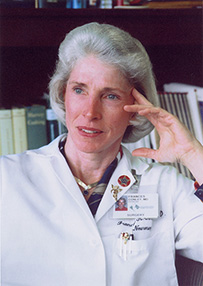 Dr. Frances K. Conley, a White female in a lab coat and badge posing for her portrait.